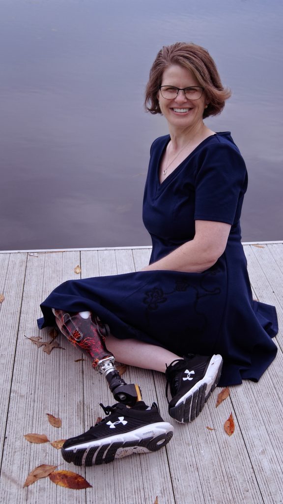 Photo of author Katie Mettner sitting on a dock.